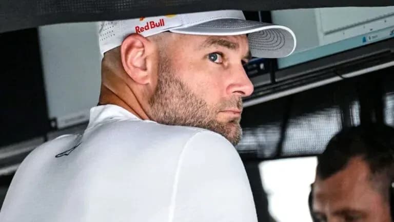 Man in Red Bull cap observing from the pit Man in Red Bull cap observing from the pit