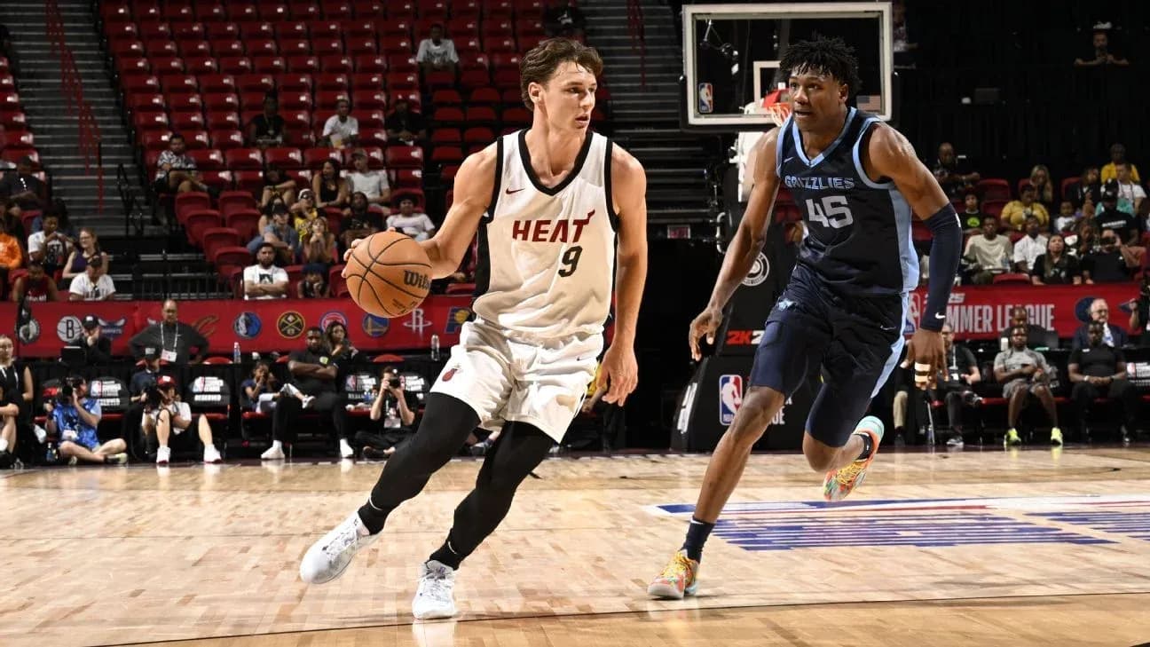 Player from Miami Heat dribbling past opponent Player from Miami Heat dribbling past opponent