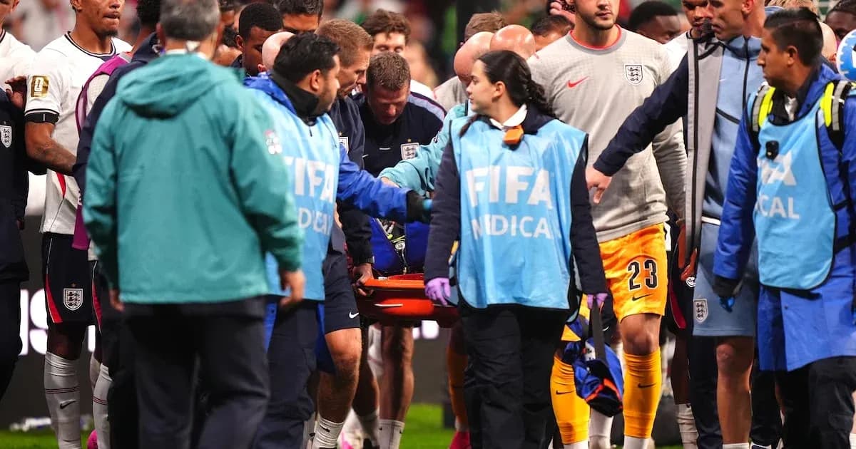 Players and medical staff attending to injured player Players and medical staff attending to injured player