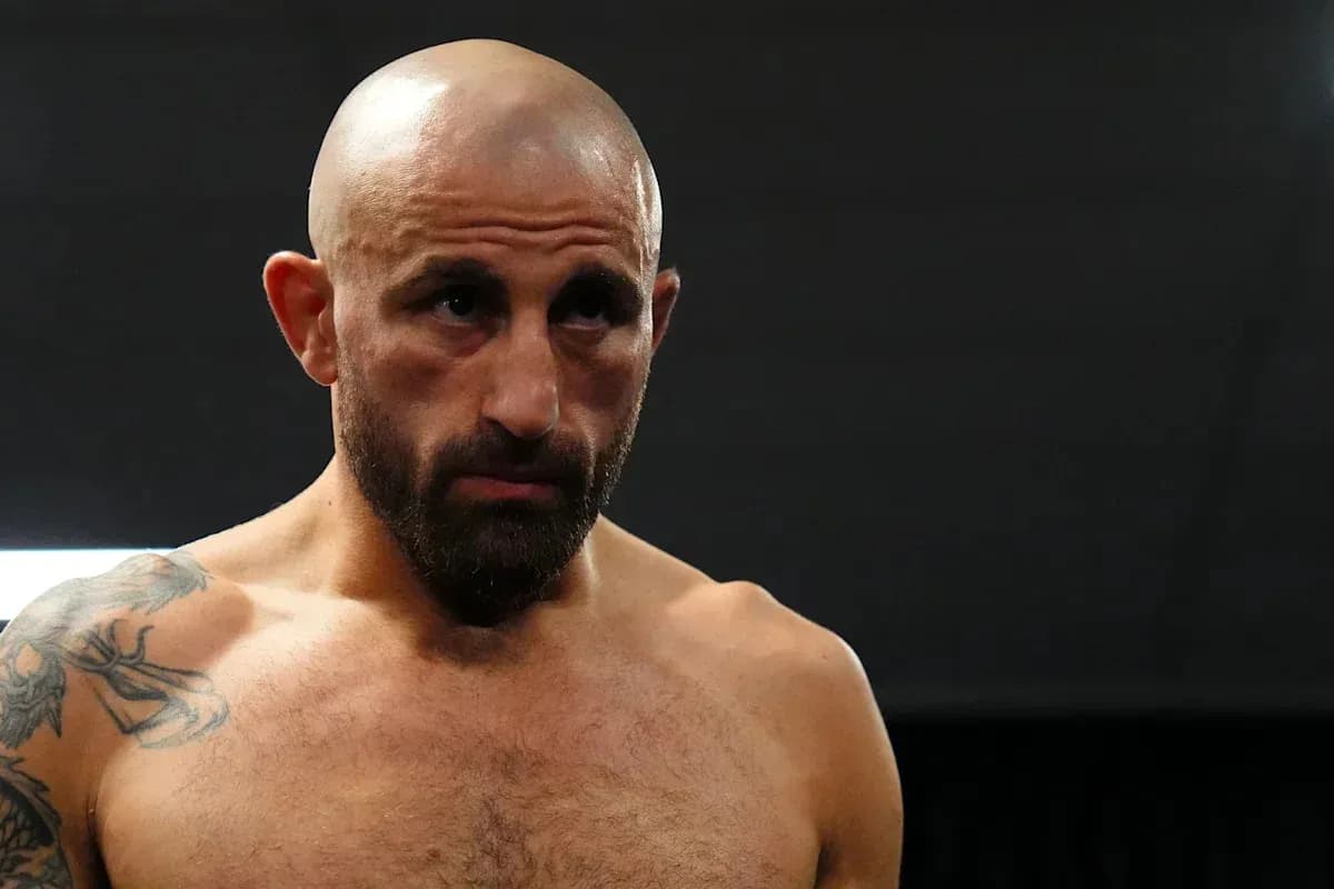 Bald fighter with tattoos in a gym setting Bald fighter with tattoos in a gym setting