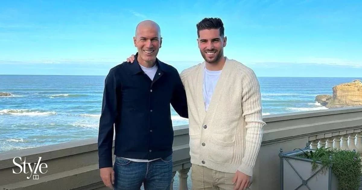 Two men posing by the ocean with blue sky Two men posing by the ocean with blue sky