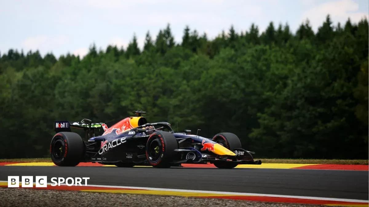 Formula 1 car racing on track surrounded by trees Formula 1 car racing on track surrounded by trees