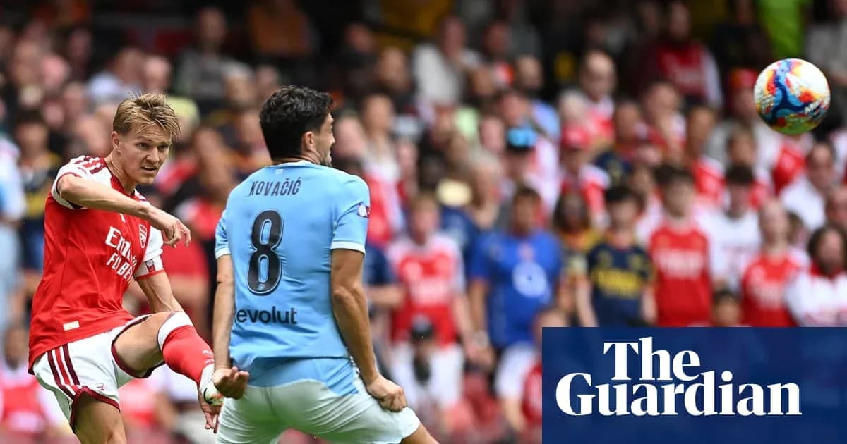 Arsenal player kicking ball towards opponent in match Arsenal player kicking ball towards opponent in match