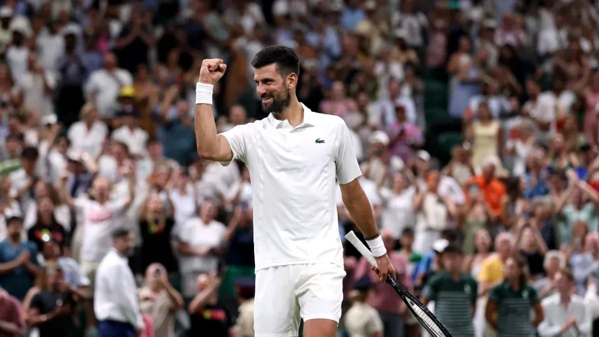 Tennis player celebrating victory in front of crowd Tennis player celebrating victory in front of crowd
