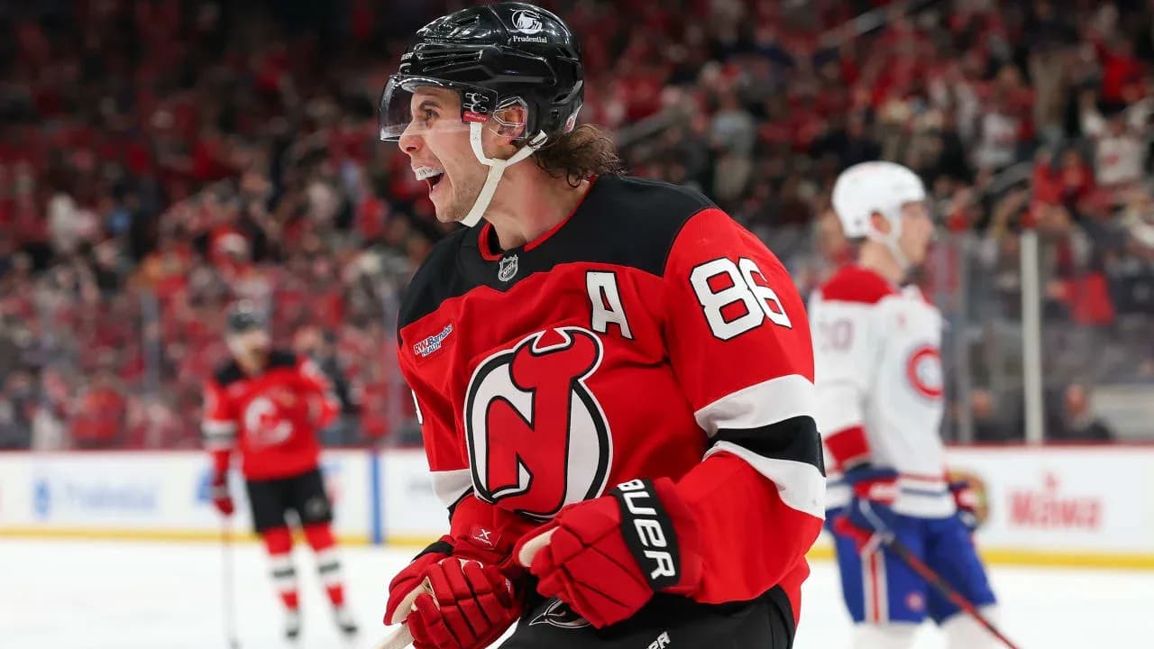 Hockey player celebrating goal in New Jersey Devils jersey Hockey player celebrating goal in New Jersey Devils jersey