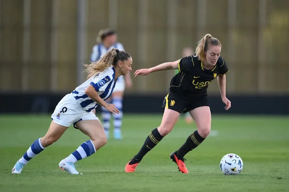 Two players competing for the ball on the field Two players competing for the ball on the field