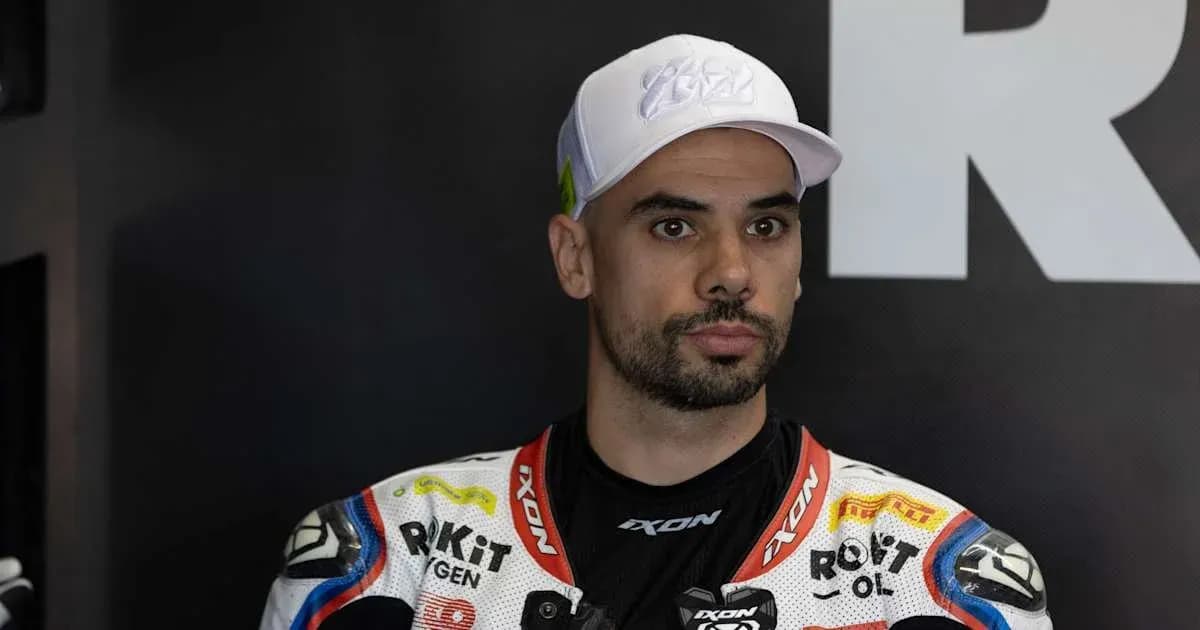 Motorsport athlete in racing gear at event Motorsport athlete in racing gear at event