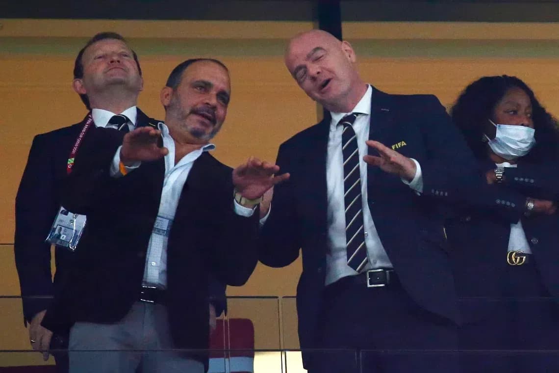 Officials interacting in VIP box during event Officials interacting in VIP box during event