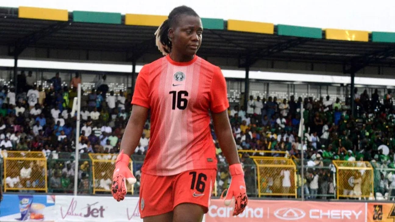 Goalkeeper wearing red jersey walking on the pitch Goalkeeper wearing red jersey walking on the pitch