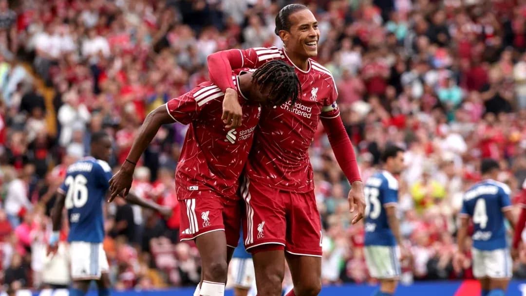 Liverpool players celebrating a goal in stadium Liverpool players celebrating a goal in stadium