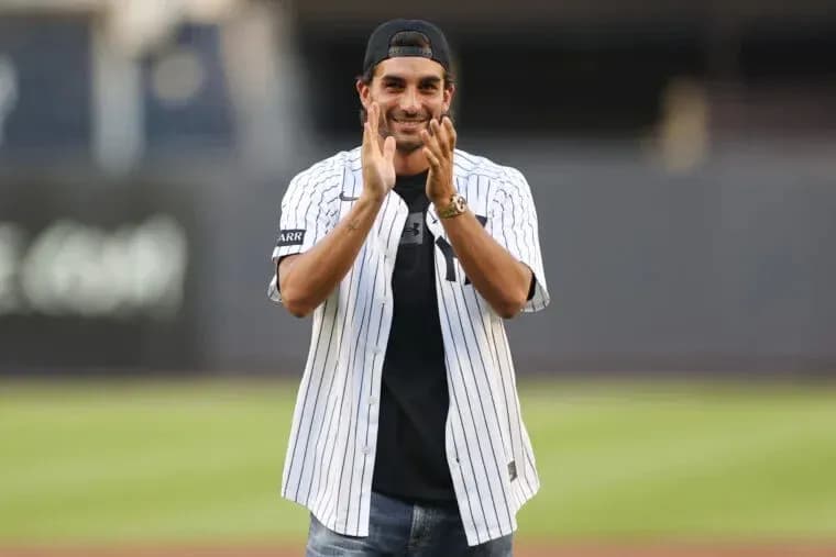 Person applauding while wearing a baseball jersey Person applauding while wearing a baseball jersey