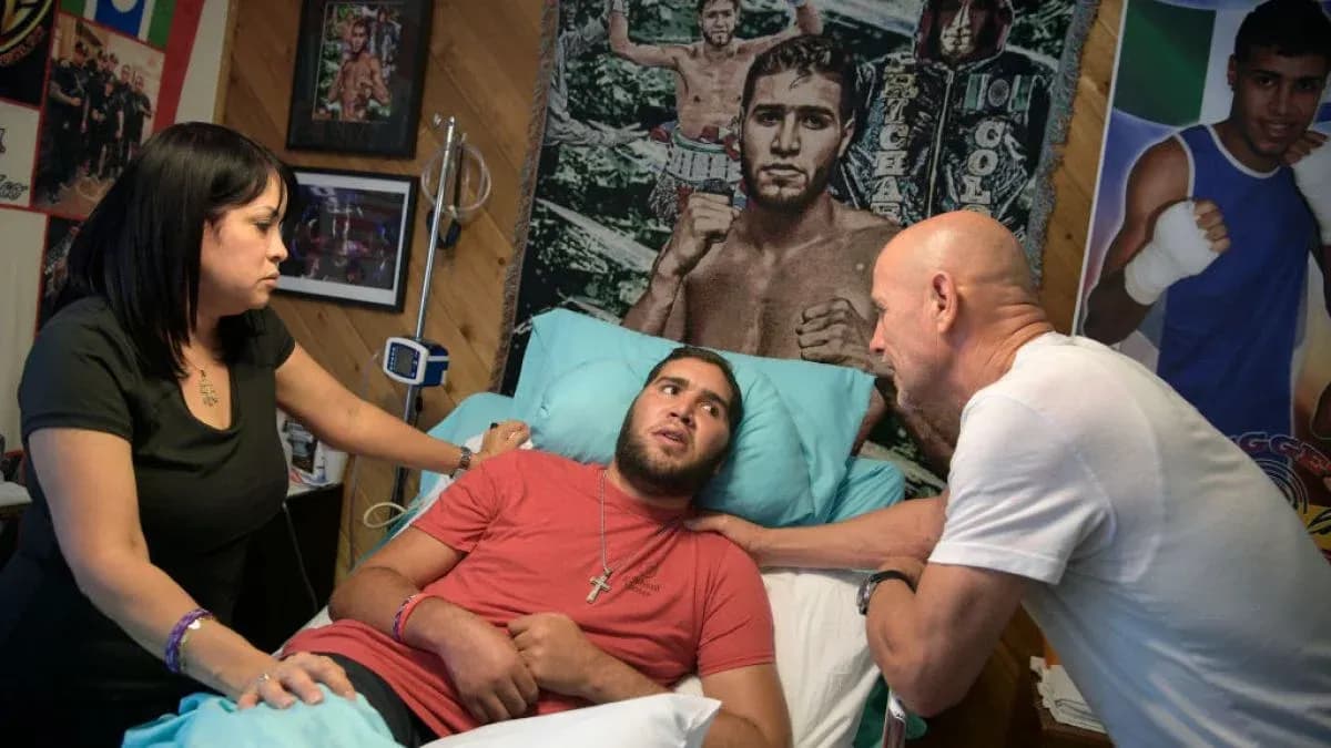 Young man in hospital bed with two visitors Young man in hospital bed with two visitors