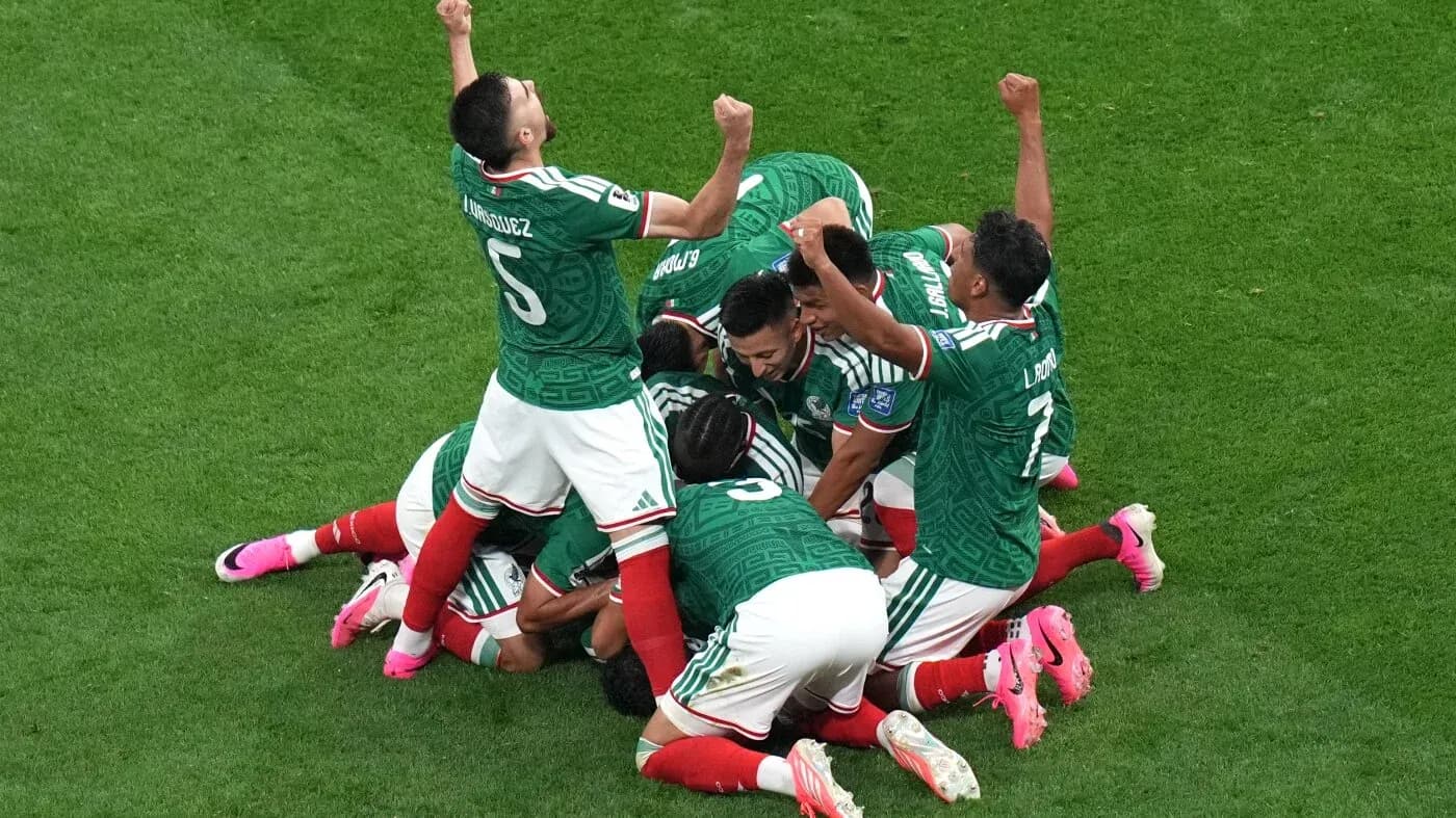 Mexican players celebrating a goal on the field Mexican players celebrating a goal on the field