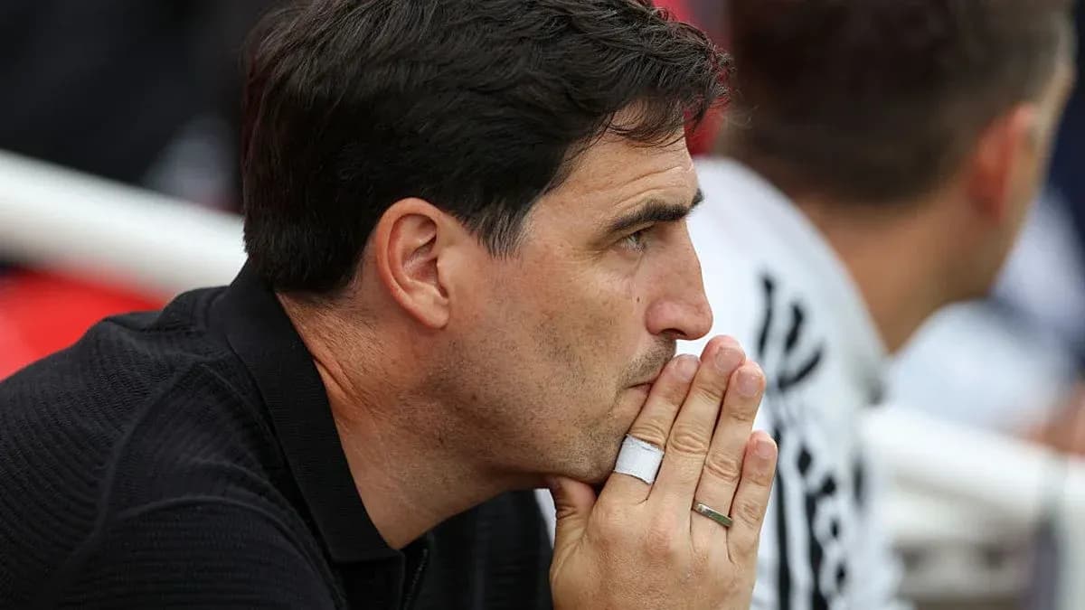 Coach observing the match with thoughtful expression Coach observing the match with thoughtful expression
