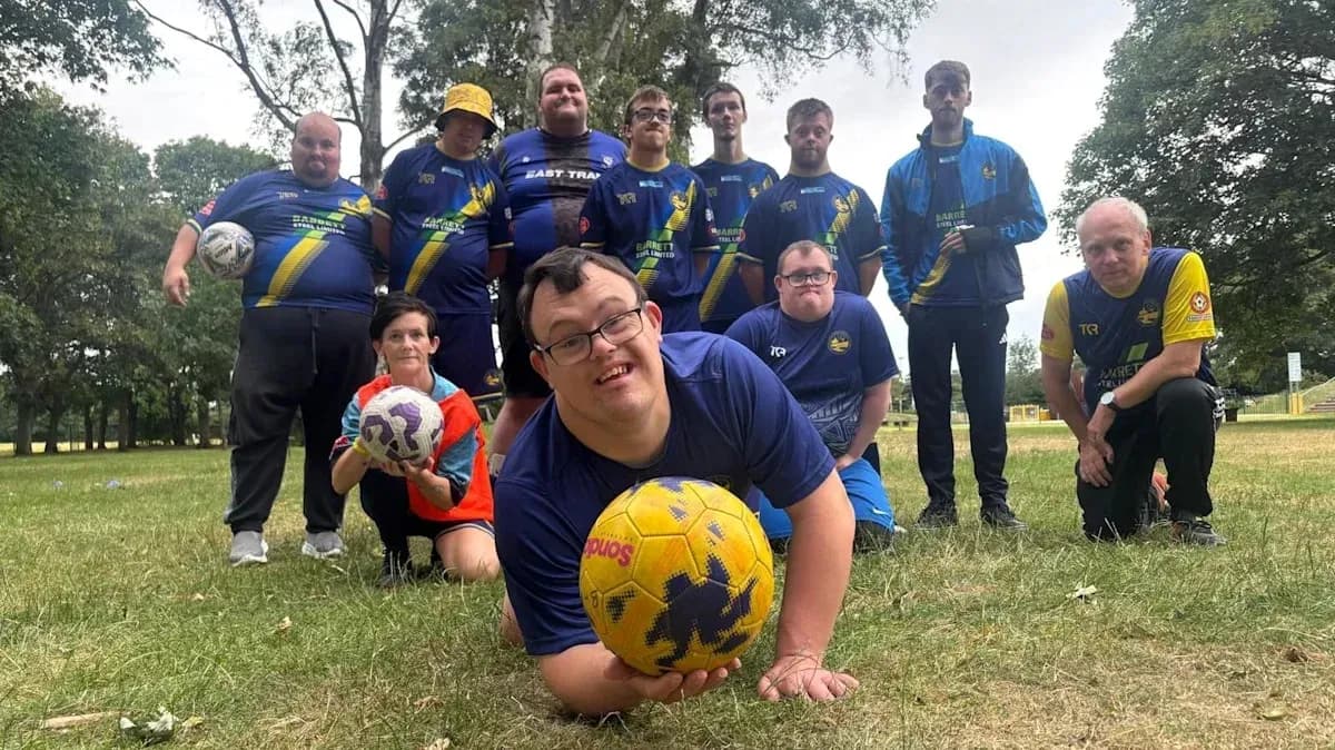 Football team posing together on grassy field Football team posing together on grassy field