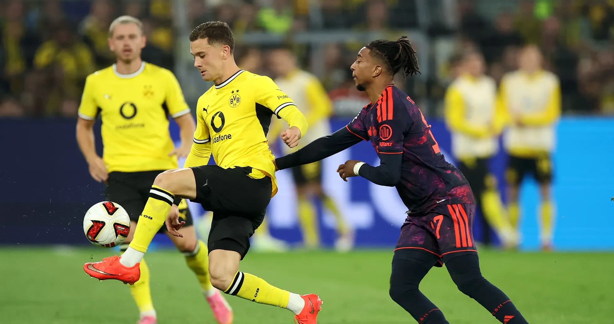 Borussia Dortmund player dribbling past opponent Borussia Dortmund player dribbling past opponent