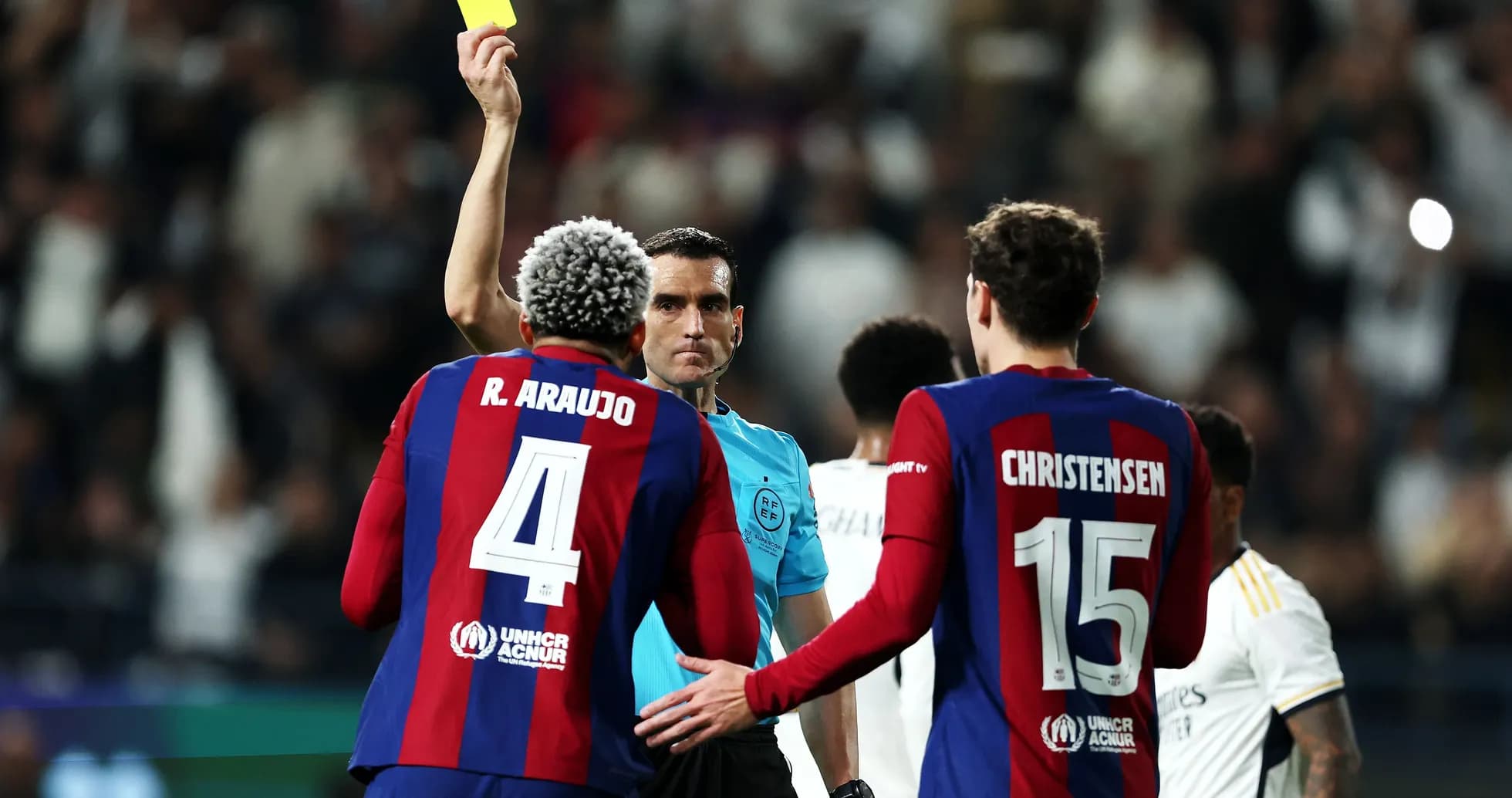 Referee shows yellow card to player during match Referee shows yellow card to player during match