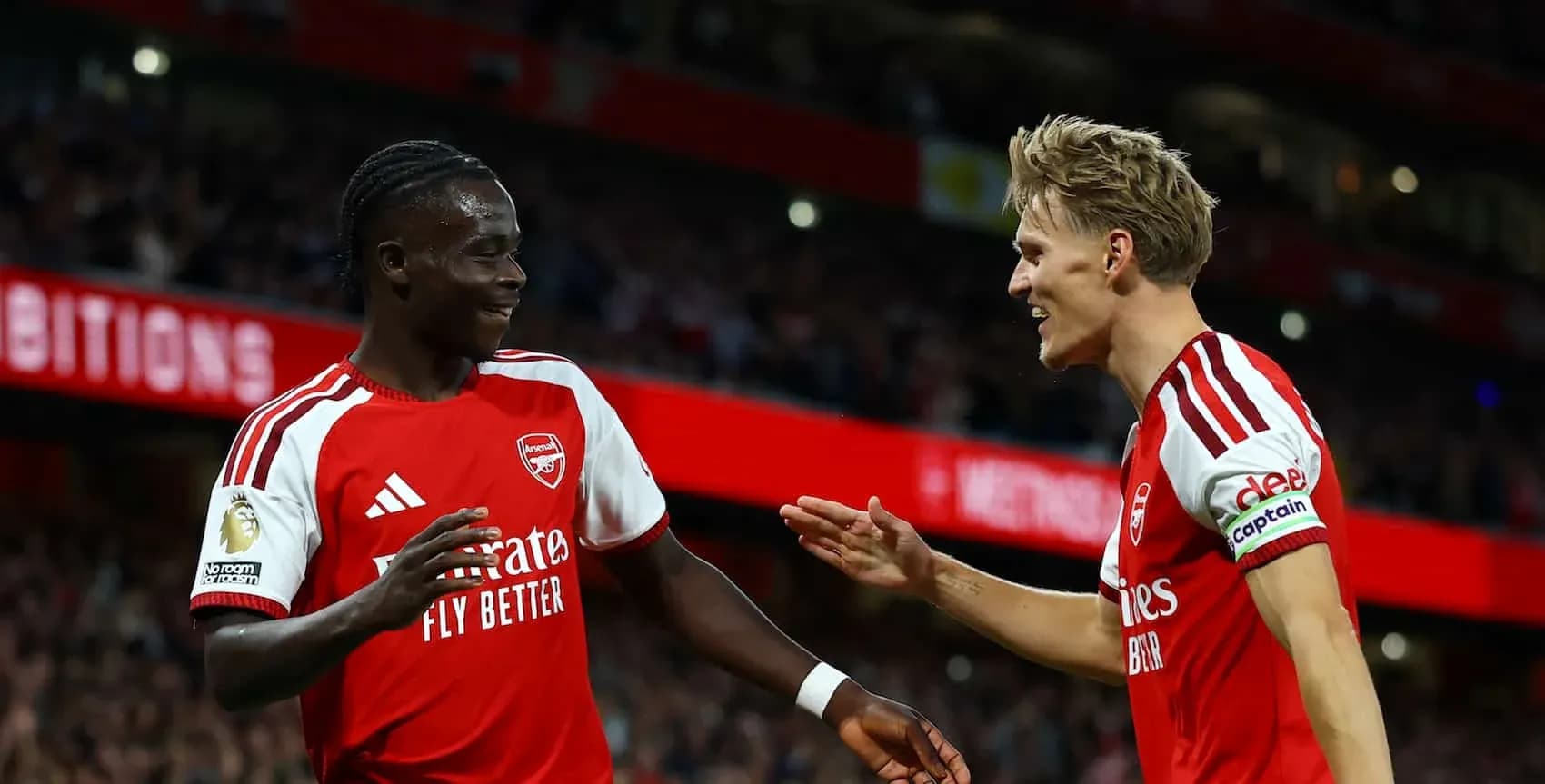 Arsenal players celebrating a goal on the pitch Arsenal players celebrating a goal on the pitch