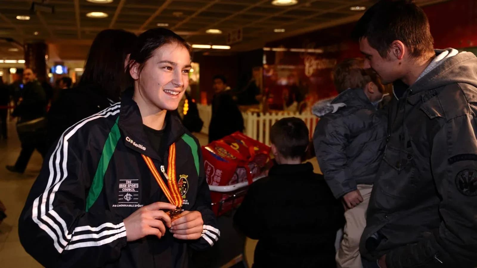Athlete wearing medal at an airport Athlete wearing medal at an airport