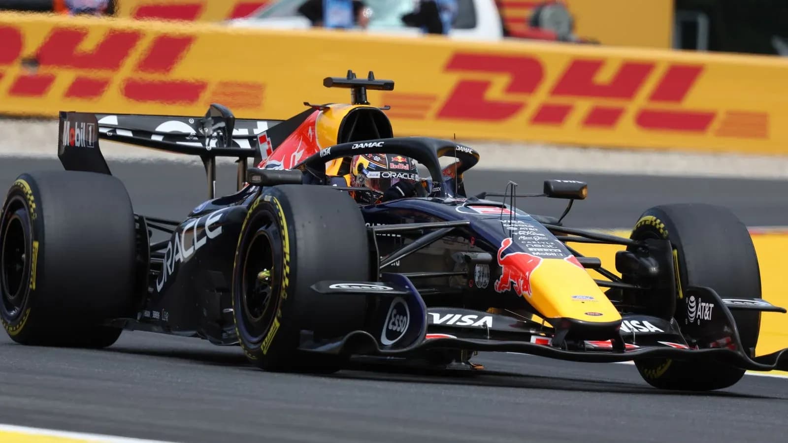 Formula 1 car racing on track with DHL backdrop Formula 1 car racing on track with DHL backdrop