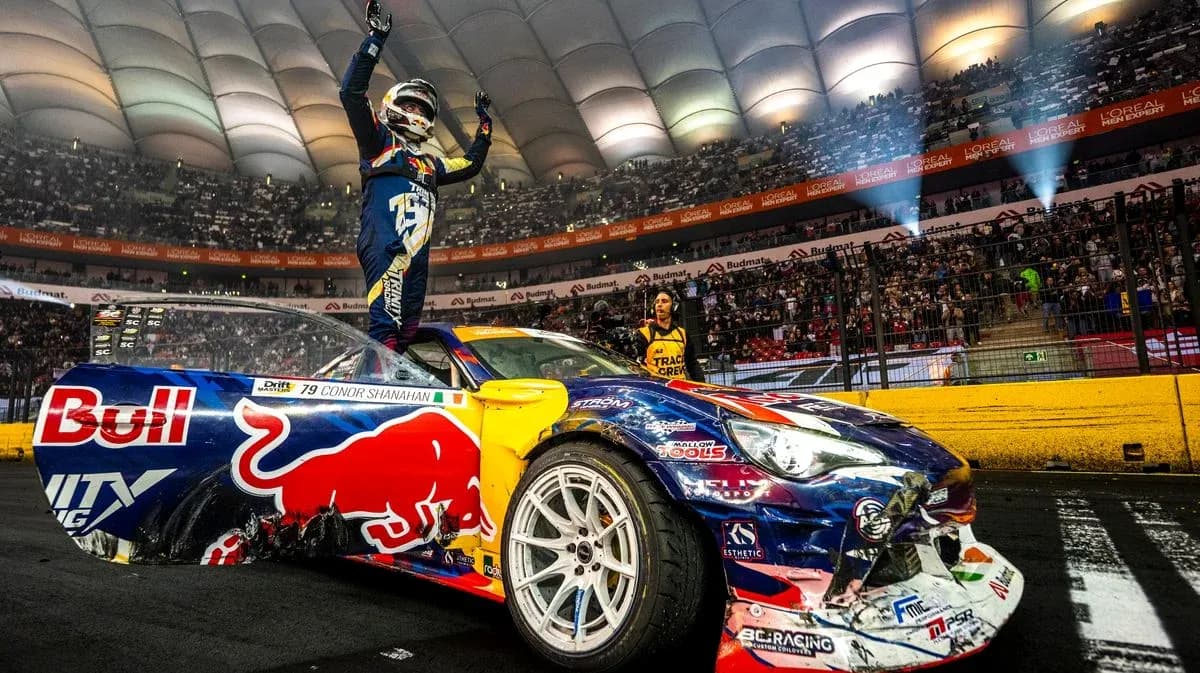 Driver celebrating on car after race victory Driver celebrating on car after race victory