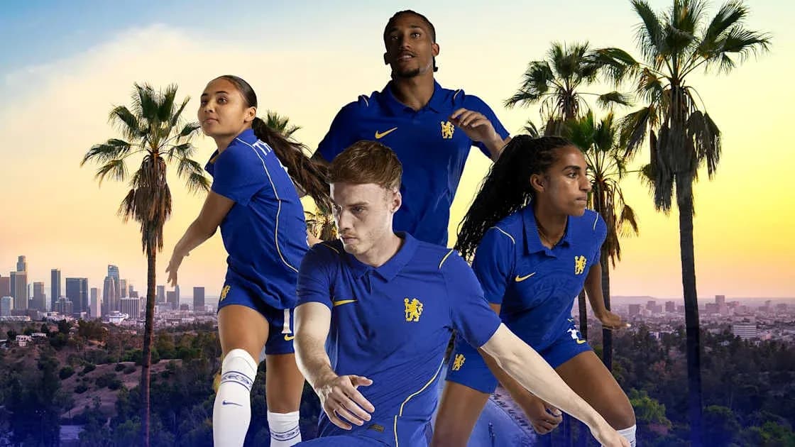 Four football players in blue kits against city backdrop Four football players in blue kits against city backdrop