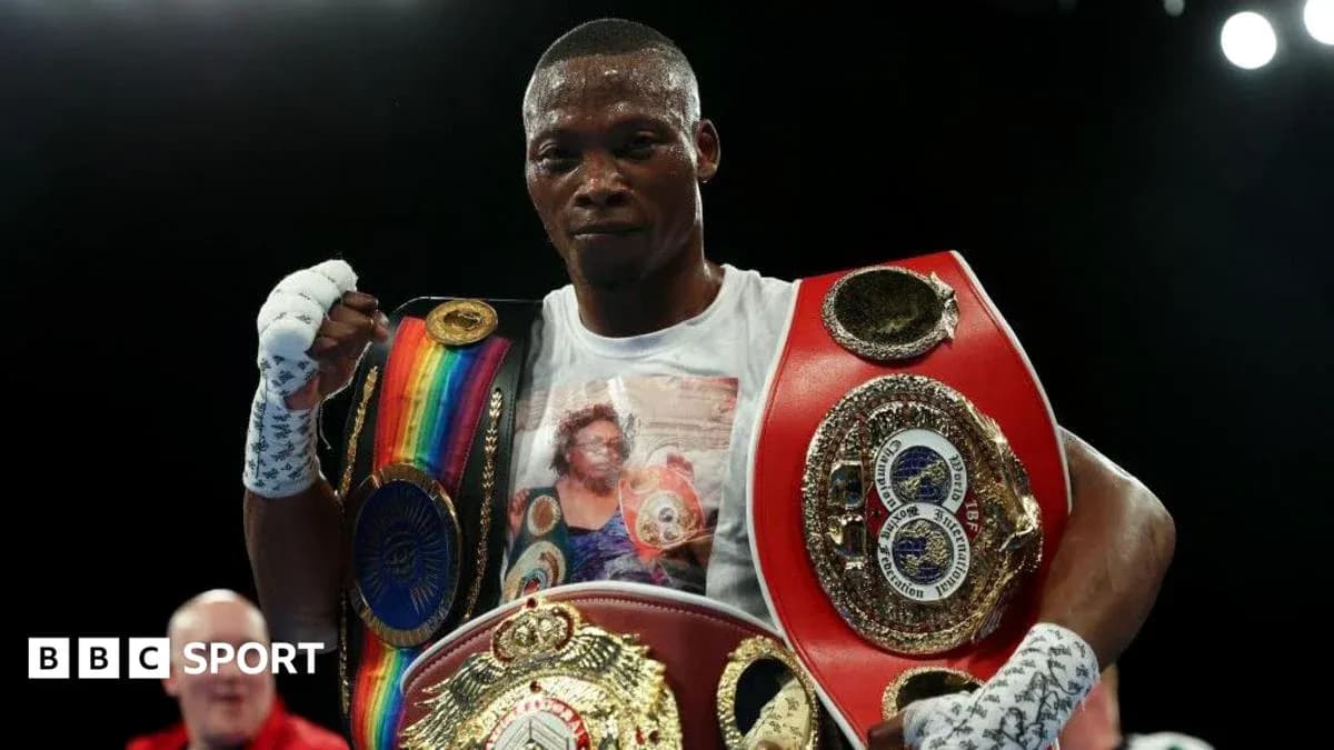 Boxer celebrating victory with multiple championship belts Boxer celebrating victory with multiple championship belts