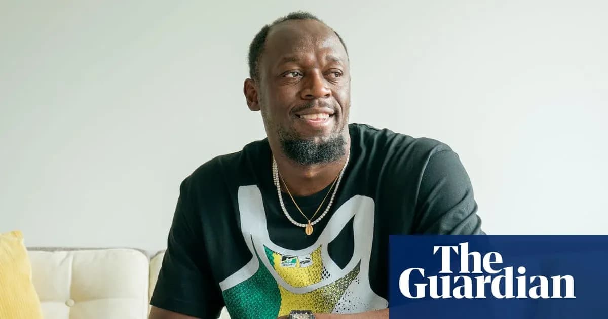 Athlete sitting on sofa, smiling in casual attire Athlete sitting on sofa, smiling in casual attire