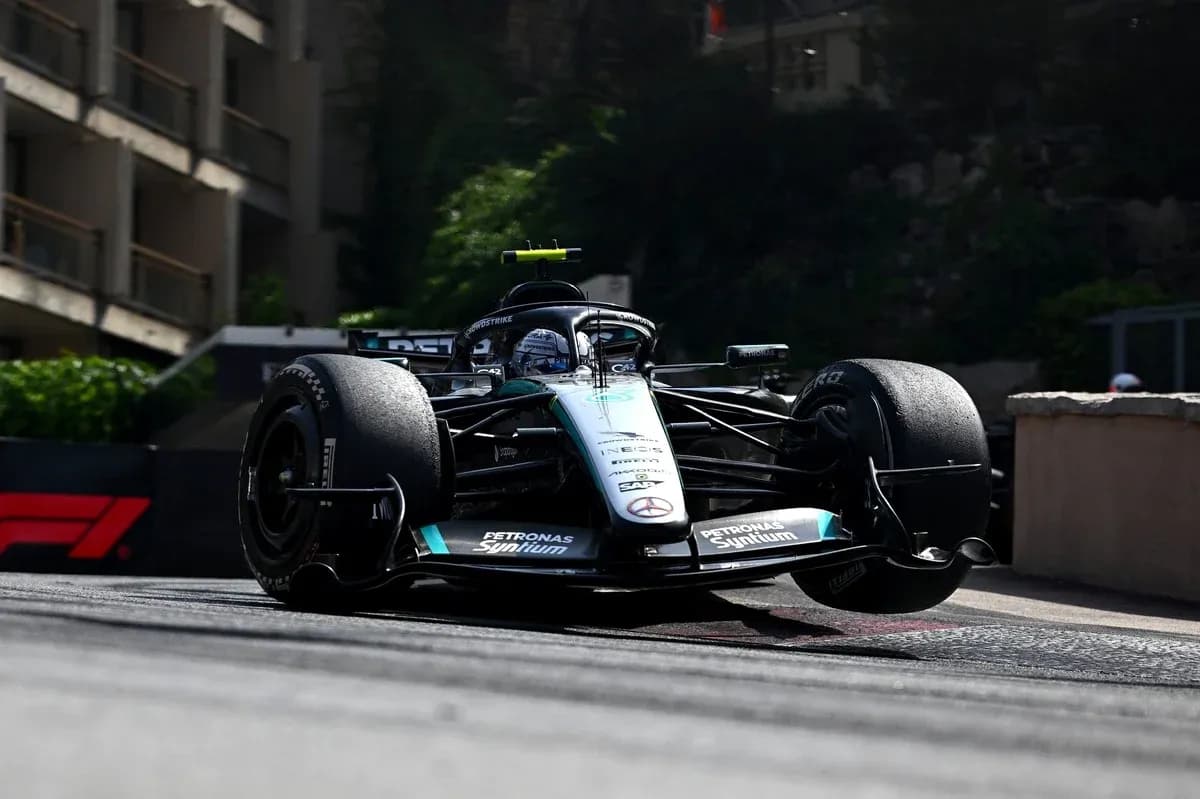 Formula 1 car racing around corner on track Formula 1 car racing around corner on track