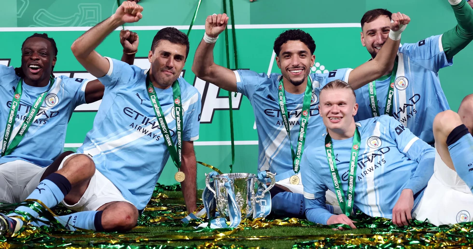 Manchester City players celebrating with trophy after victory Manchester City players celebrating with trophy after victory
