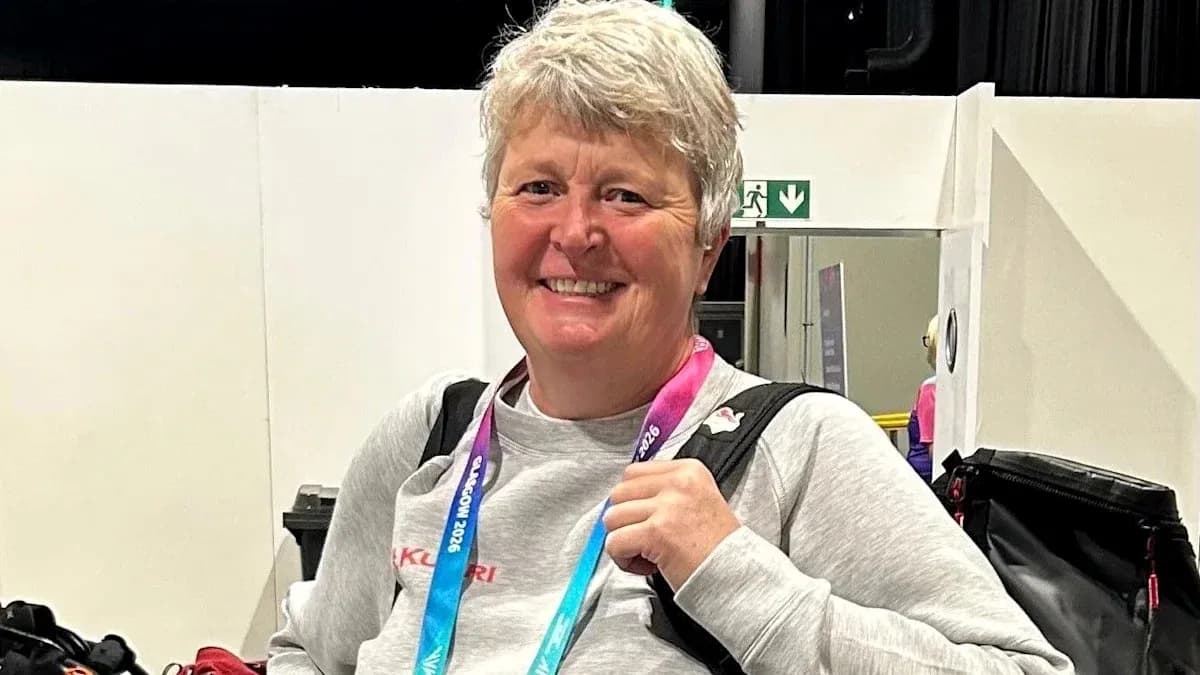 Woman smiling with a backpack and medals Woman smiling with a backpack and medals