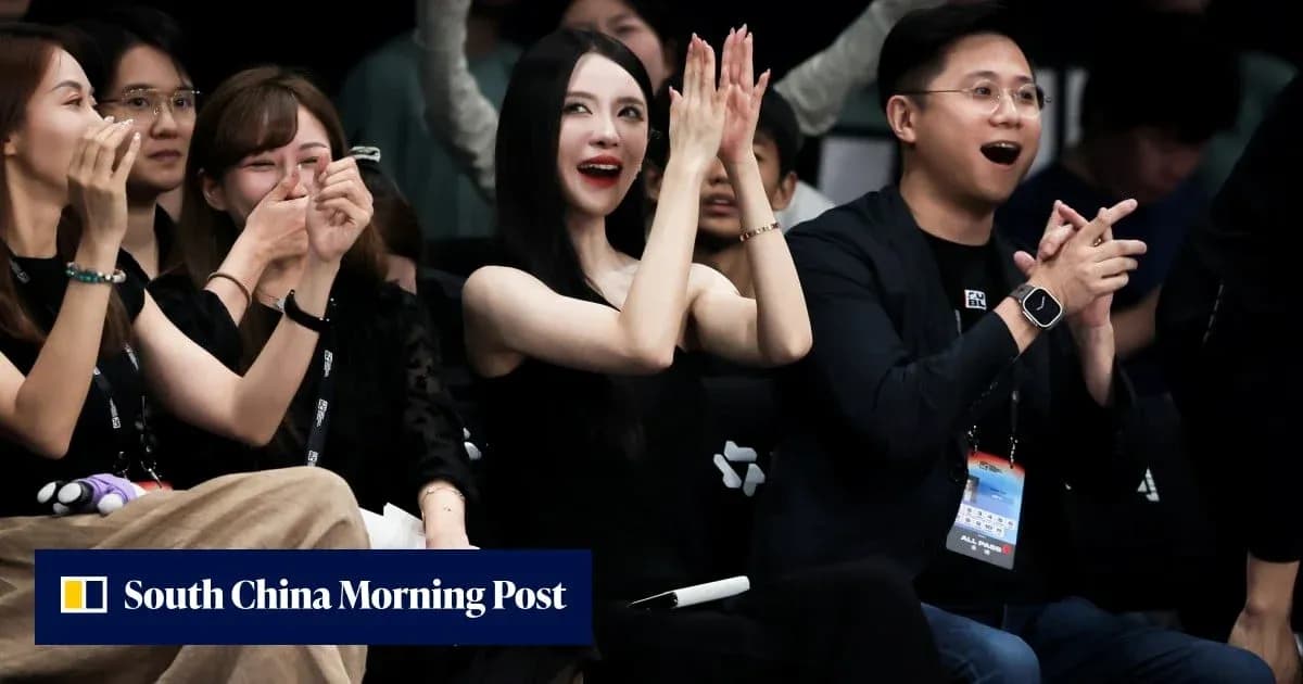 Audience members cheering at an event Audience members cheering at an event