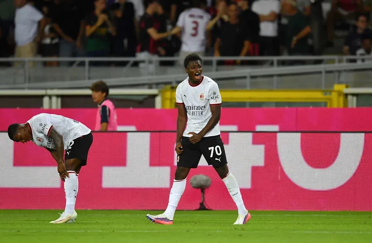 AC Milan players celebrating a goal on field AC Milan players celebrating a goal on field