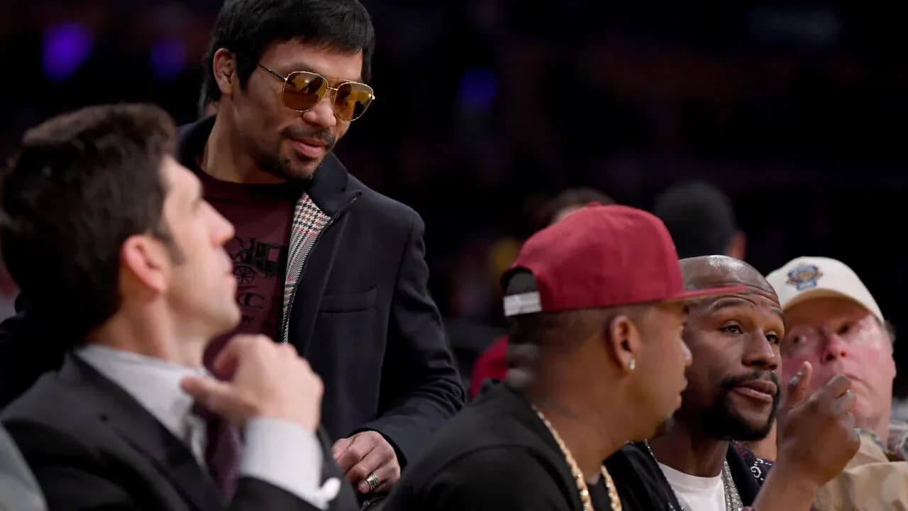 Manny Pacquiao talking with friends at an event Manny Pacquiao talking with friends at an event