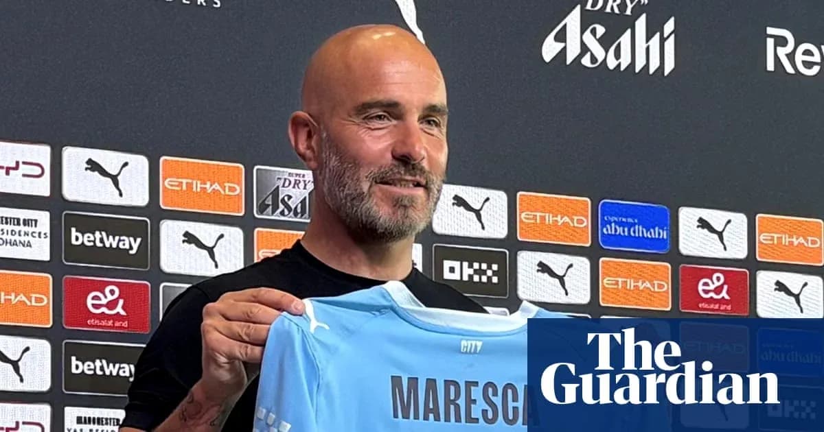 Men's football manager holding Manchester City jersey Men's football manager holding Manchester City jersey