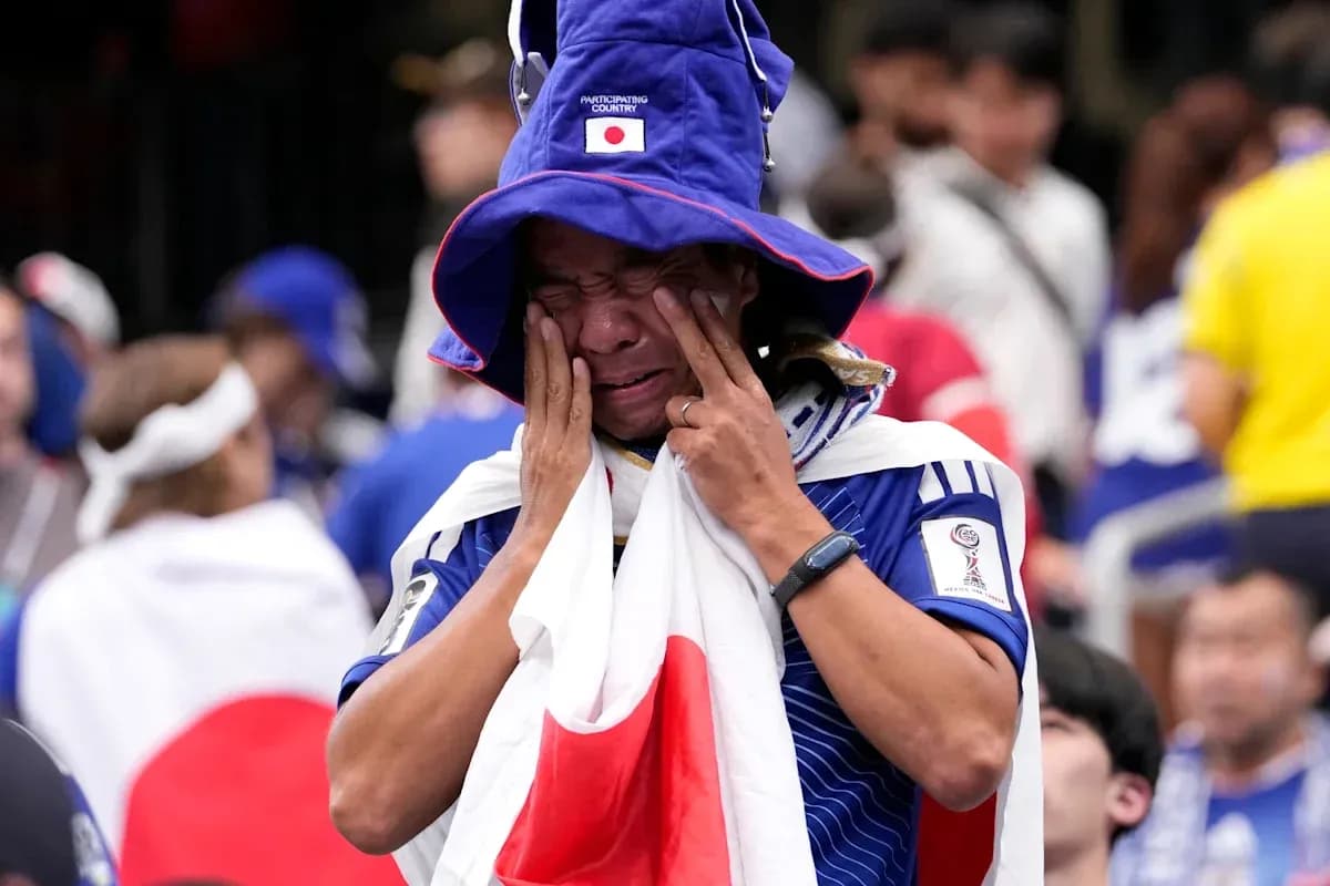 Fan wearing Japanese flag, showing emotional reaction Fan wearing Japanese flag, showing emotional reaction