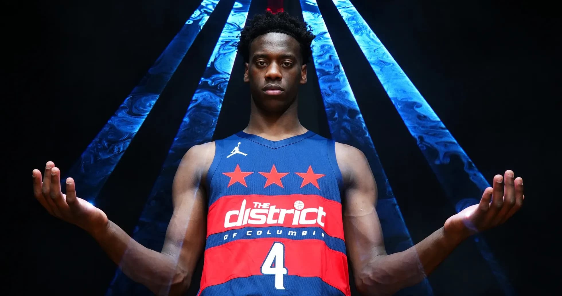 Basketball player in jersey posing with arms outstretched Basketball player in jersey posing with arms outstretched