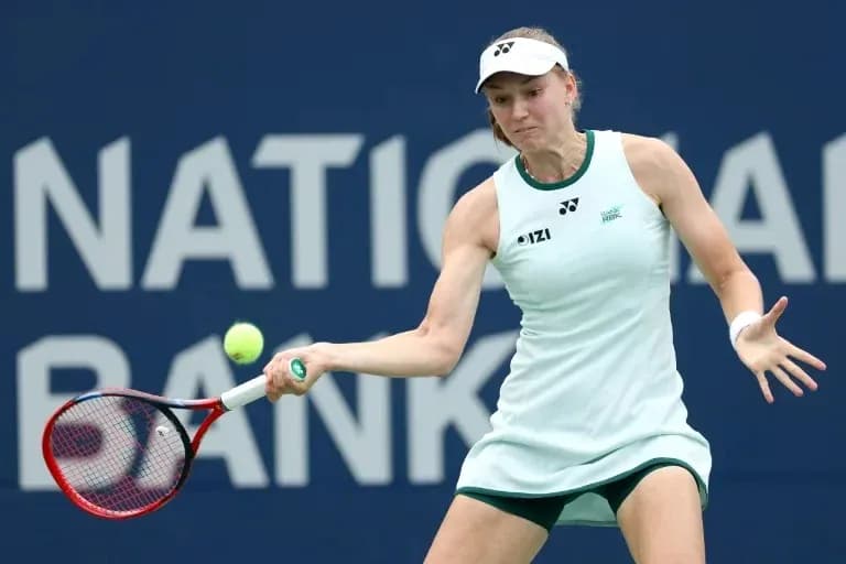 Tennis player hitting a backhand shot on court Tennis player hitting a backhand shot on court