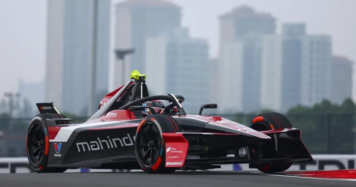 Mahindra racing car on track with city skyline Mahindra racing car on track with city skyline