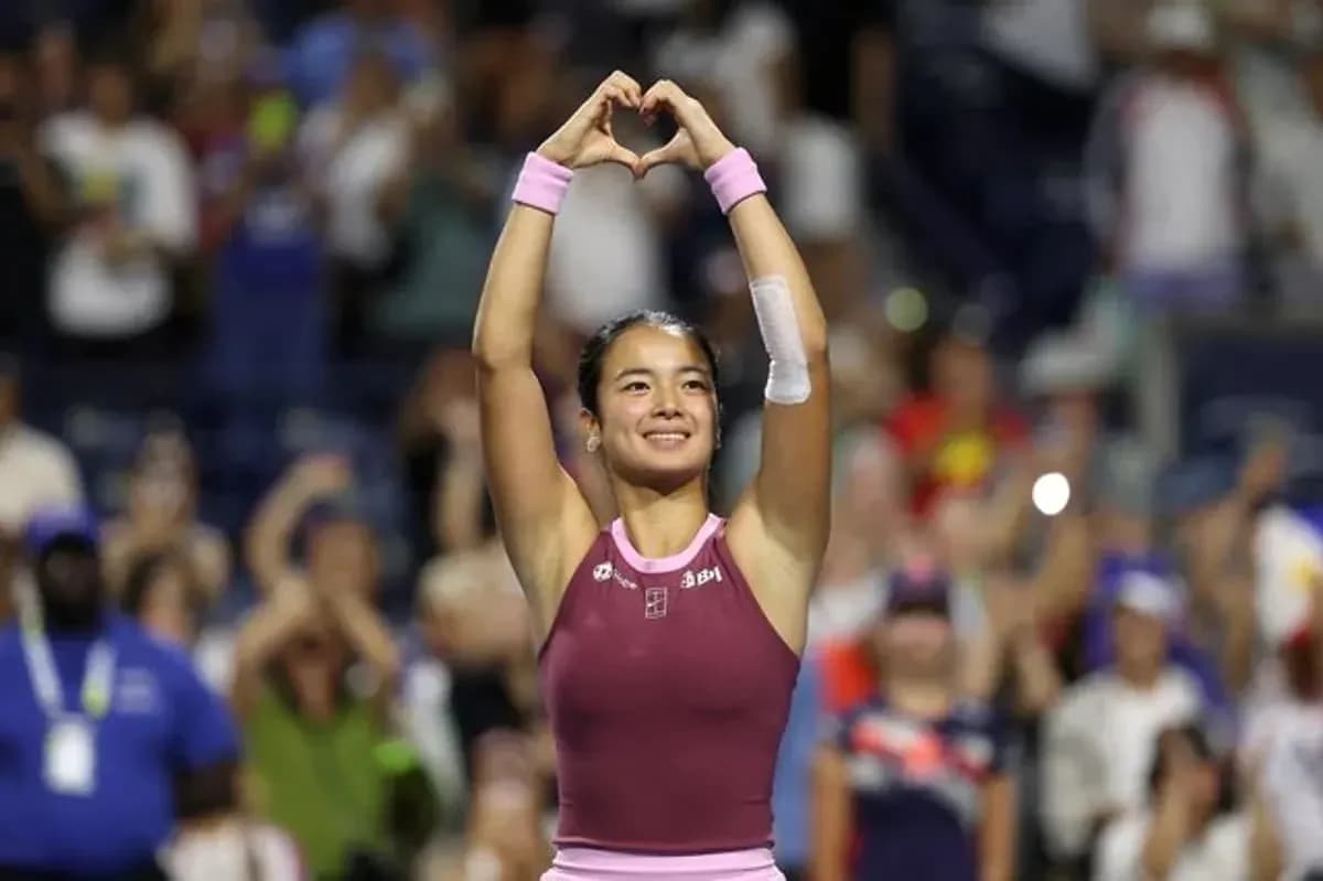 Tennis player celebrating with heart gesture after match Tennis player celebrating with heart gesture after match