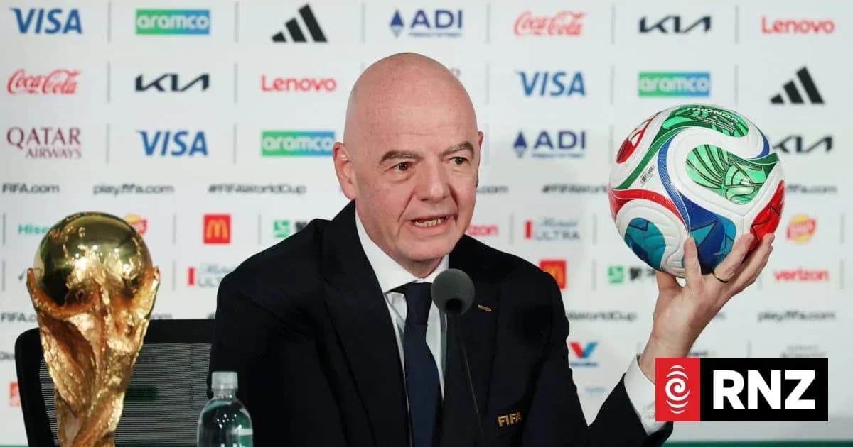 FIFA president holding World Cup trophy and ball FIFA president holding World Cup trophy and ball