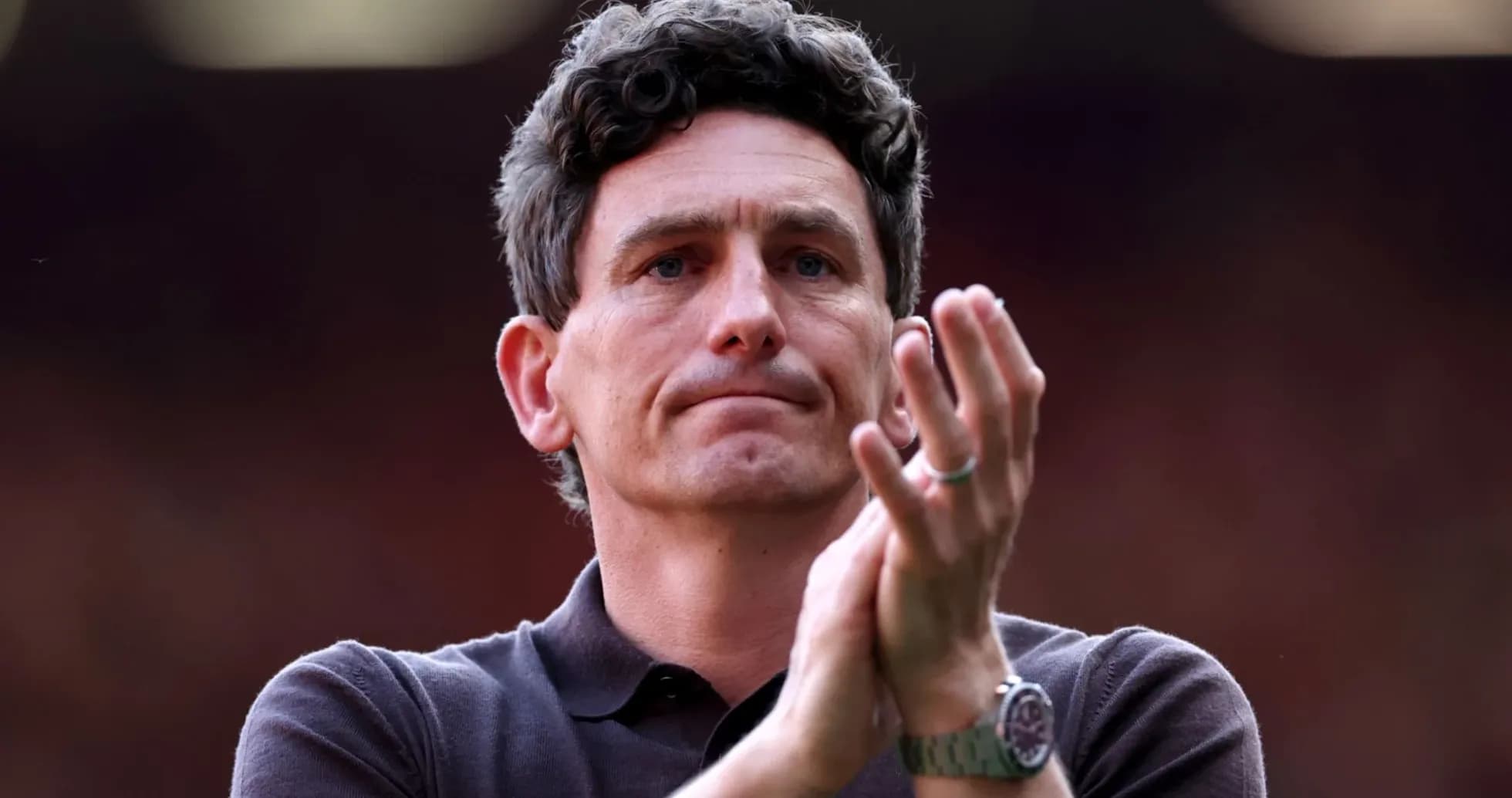 Coach applauding during a match or event Coach applauding during a match or event