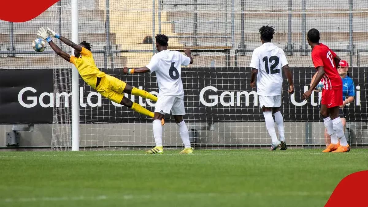 Goalkeeper diving to save a shot on goal Goalkeeper diving to save a shot on goal