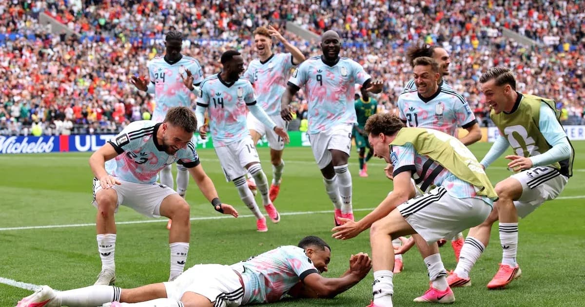 Football players celebrating a goal on the pitch Football players celebrating a goal on the pitch