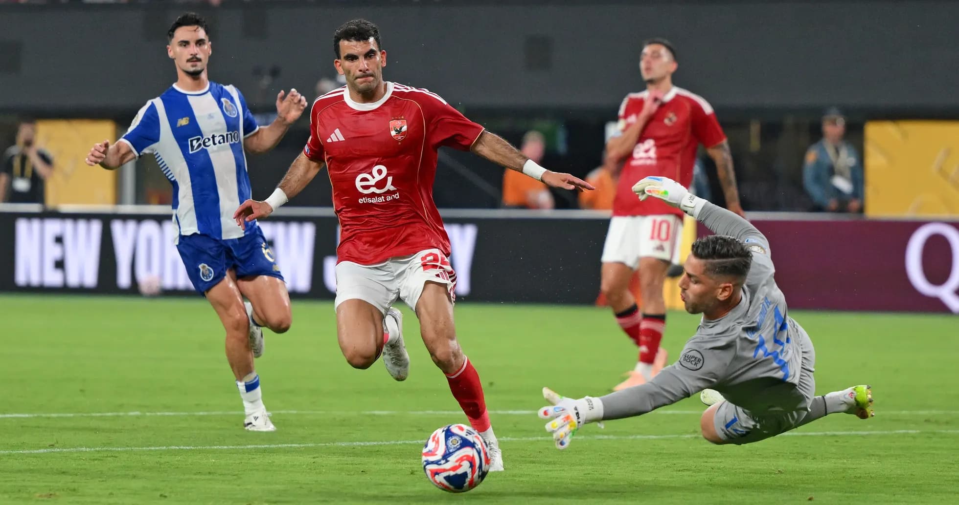 Player attempting to score against goalkeeper in match Player attempting to score against goalkeeper in match