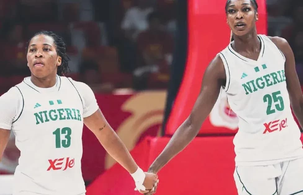 Two Nigerian players holding hands during a game Two Nigerian players holding hands during a game