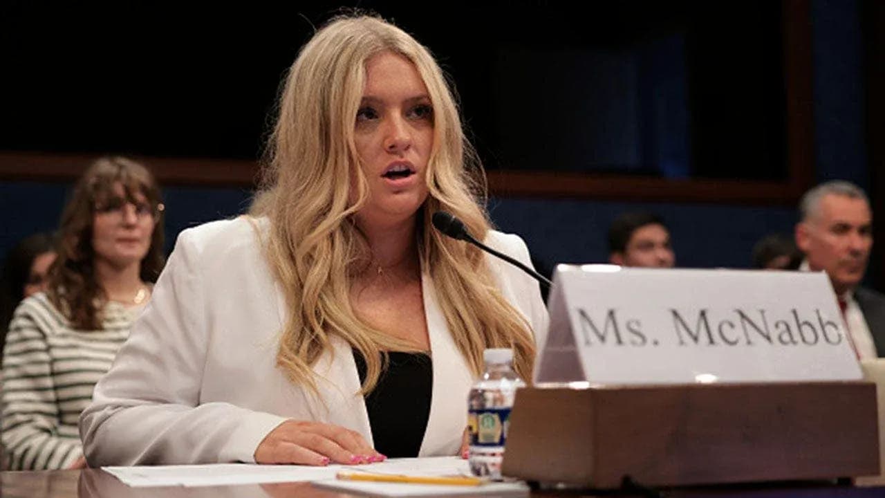 Woman testifying at congressional hearing with audience Woman testifying at congressional hearing with audience