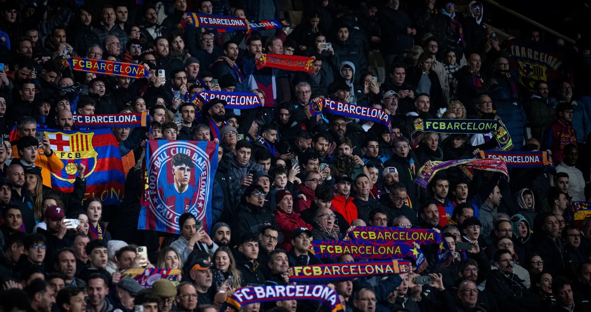 FC Barcelona fans holding scarves in stadium FC Barcelona fans holding scarves in stadium