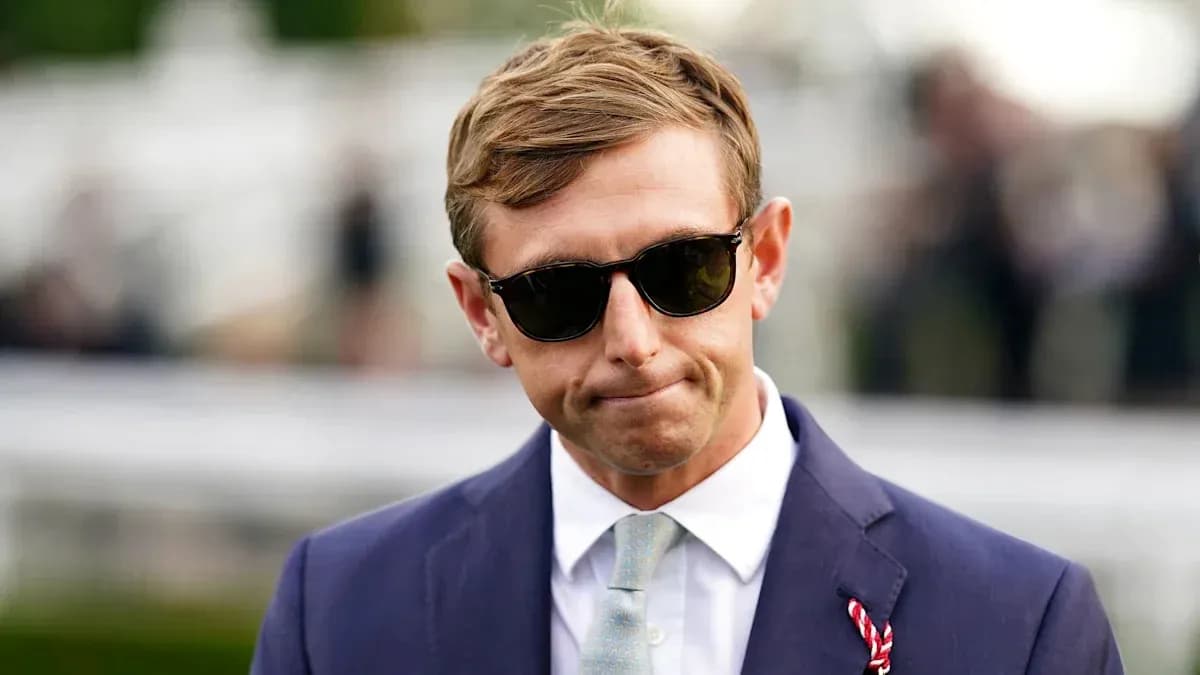 Man in sunglasses wearing a suit at event Man in sunglasses wearing a suit at event