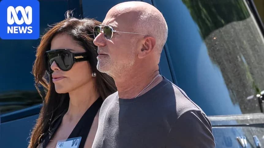 Two people walking together in sunglasses Two people walking together in sunglasses